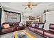Living room with leather sofas and access to backyard at 2907 Sunset Lakes Blvd, Kissimmee, FL 34747
