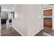 Clean hallway with dark flooring connecting living and kitchen areas at 2907 Sunset Lakes Blvd, Kissimmee, FL 34747