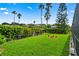 Landscaped backyard with lush greenery and a circular garden at 2907 Sunset Lakes Blvd, Kissimmee, FL 34747
