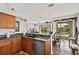 Kitchen with breakfast bar, granite counters, and view to dining area at 2907 Sunset Lakes Blvd, Kissimmee, FL 34747