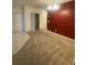 Simple dining room with red accent wall and carpet flooring at 2581 Wadeview Loop, Saint Cloud, FL 34769