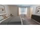 Spacious bedroom with large bed, window with blinds, and a dark dresser at 1955 Hemingway Cir, Groveland, FL 34736