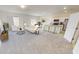 Open living room and kitchen with island and neutral colors at 1955 Hemingway Cir, Groveland, FL 34736