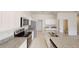 Modern kitchen with white cabinets, granite countertops, and stainless steel appliances at 1955 Hemingway Cir, Groveland, FL 34736