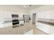 Modern kitchen island with granite countertops and stainless steel appliances at 1955 Hemingway Cir, Groveland, FL 34736