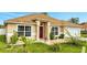 One-story house with attached garage and landscaped front yard at 1016 Derbyshire Dr, Kissimmee, FL 34758