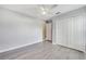 Bedroom with ceiling fan, double door closet, and wood-look flooring at 1016 Derbyshire Dr, Kissimmee, FL 34758