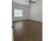 Bright bedroom featuring wood-look floors and a window with blinds at 6891 Old Melbourne Hwy, Saint Cloud, FL 34771