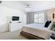 Main bedroom with TV, dresser, and large bed at 8976 Amelia Downs Trl, Kissimmee, FL 34747