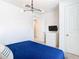 Bedroom with a blue comforter and a modern chandelier at 8976 Amelia Downs Trl, Kissimmee, FL 34747