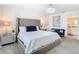 Spacious main bedroom with plush bed and ensuite bathroom at 8976 Amelia Downs Trl, Kissimmee, FL 34747