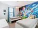 Fun ' bedroom with twin beds, Mario theme wall, and cheerful decor at 8976 Amelia Downs Trl, Kissimmee, FL 34747