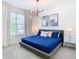 Primary bedroom with large bed and modern decor at 8976 Amelia Downs Trl, Kissimmee, FL 34747