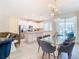 Elegant dining room with glass table and modern chandelier at 8976 Amelia Downs Trl, Kissimmee, FL 34747