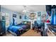 Bright bedroom featuring a full-size bed and gaming setup at 2727 N Juliet Dr, Deltona, FL 32738