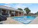 Inviting pool area with lounge chairs and a stone fire pit at 2727 N Juliet Dr, Deltona, FL 32738