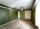 Green-walled bedroom with ceiling fan and closet at 14534 Potanow Trl, Orlando, FL 32837