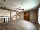 Spacious loft area with carpet, ceiling fan, and built-in bookcase at 14534 Potanow Trl, Orlando, FL 32837