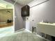 Laundry room with cabinets, sink, and tiled floor at 14534 Potanow Trl, Orlando, FL 32837