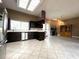 Kitchen with breakfast bar, stainless steel appliances, and view to Gathering room at 14534 Potanow Trl, Orlando, FL 32837