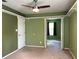 Bedroom with ceiling fan, carpet, and access to another room at 14534 Potanow Trl, Orlando, FL 32837