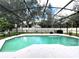 Inviting screened-in pool with surrounding plants at 14534 Potanow Trl, Orlando, FL 32837