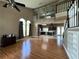 Two-story living room with hardwood floors, high ceilings, and staircase at 14534 Potanow Trl, Orlando, FL 32837