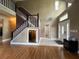 Two-story entryway with hardwood floors, staircase, and hidden storage at 14534 Potanow Trl, Orlando, FL 32837