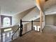 Upstairs hallway with carpeted flooring and views of the living room at 14534 Potanow Trl, Orlando, FL 32837
