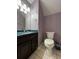 Small bathroom with dark vanity and tiled floor at 14534 Potanow Trl, Orlando, FL 32837