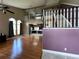 Two-story living room with hardwood floors, open floor plan, and kitchen view at 14534 Potanow Trl, Orlando, FL 32837