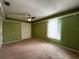 Green-walled bedroom with ceiling fan and closet at 14534 Potanow Trl, Orlando, FL 32837