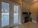 Gathering room with fireplace and French doors leading to the pool at 14534 Potanow Trl, Orlando, FL 32837