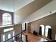 Upstairs hallway with carpeted flooring and views of the living room at 14534 Potanow Trl, Orlando, FL 32837