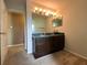 Bathroom with double vanity, mirror, and light fixtures at 14534 Potanow Trl, Orlando, FL 32837