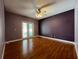 Spacious bedroom with hardwood floors and access to backyard at 14534 Potanow Trl, Orlando, FL 32837
