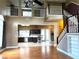 Two-story living room with hardwood floors, high ceilings, and a view of the kitchen at 14534 Potanow Trl, Orlando, FL 32837