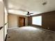 Spacious loft area with carpet, ceiling fan, and built-in bookcase at 14534 Potanow Trl, Orlando, FL 32837
