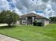 One-story house with a gray exterior and green lawn at 4260 Climbing Aster Ct, Saint Cloud, FL 34772