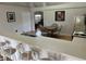 Kitchen with breakfast bar, light countertops, and a view into the dining area at 4260 Climbing Aster Ct, Saint Cloud, FL 34772