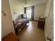 bedroom with dinosaur bedding, wooden dresser, and light floors at 4260 Climbing Aster Ct, Saint Cloud, FL 34772