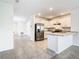Open concept kitchen with stainless steel appliances and white cabinetry at 2222 Elmsford Pt, Sanford, FL 32771