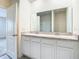 Double vanity bathroom with granite countertop and white cabinets at 2222 Elmsford Pt, Sanford, FL 32771