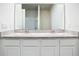 Double vanity bathroom with granite countertop and white cabinets at 2222 Elmsford Pt, Sanford, FL 32771