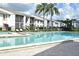 Community pool with lounge chairs and surrounding landscaping at 954 Courtyard Ln # 11, Orlando, FL 32825