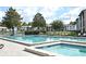 Relaxing community pool and spa area with lounge chairs at 954 Courtyard Ln # 11, Orlando, FL 32825