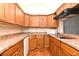 Kitchen with wood cabinets, gas cooktop, and microwave at 954 Courtyard Ln # 11, Orlando, FL 32825