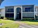 Two-story building exterior with screened balconies and stairs at 954 Courtyard Ln # 11, Orlando, FL 32825