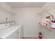 Laundry room with washer, dryer, and ample storage shelves at 954 Courtyard Ln # 11, Orlando, FL 32825