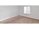Bright bedroom with neutral carpeting and window at 954 Courtyard Ln # 11, Orlando, FL 32825